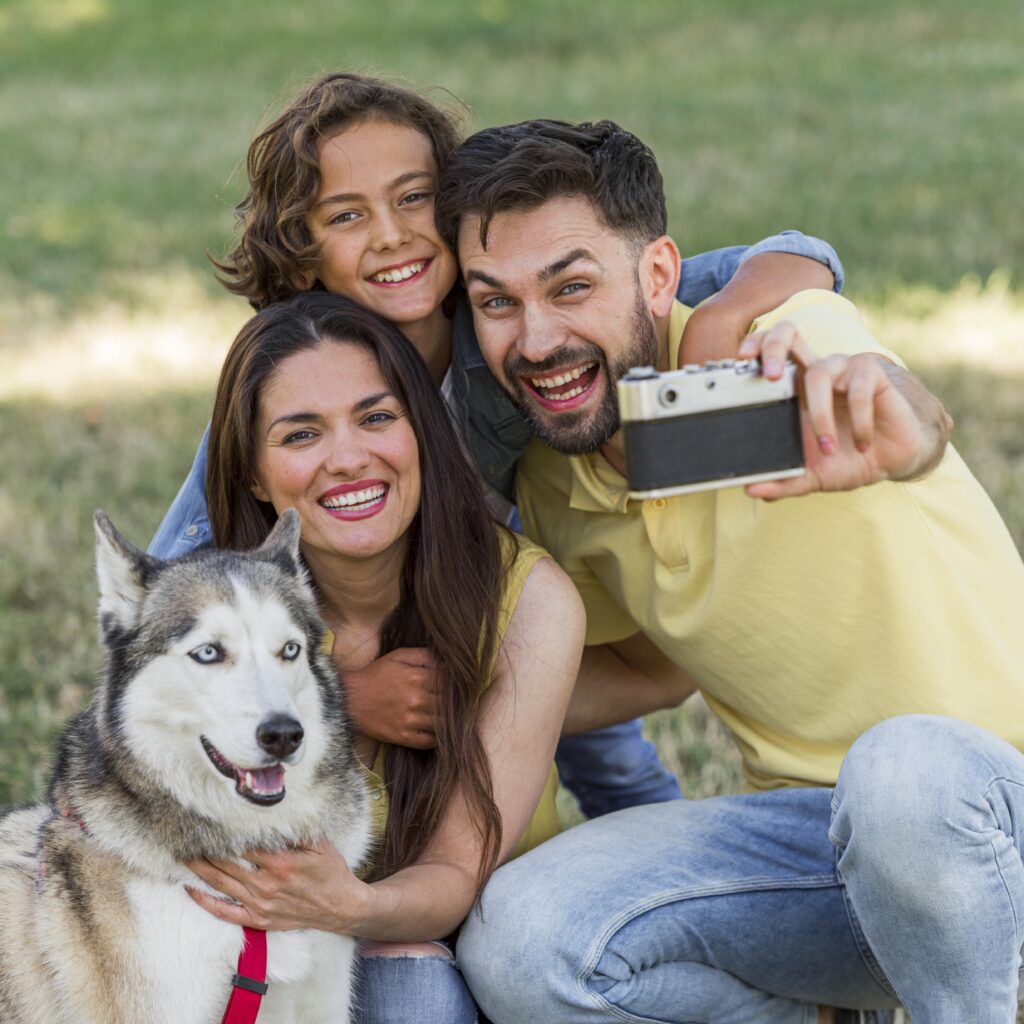 "Happy cat and dog with pet insurance documents on a table"