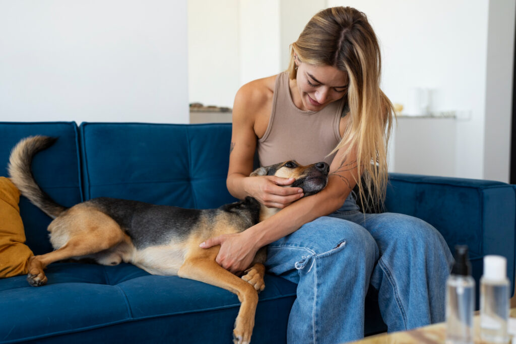 Happy dog owner comforting their dog during a vet visit in 2025